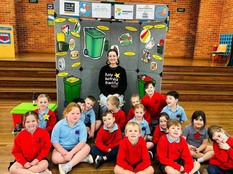 Students in the hall and images of environmental messages.