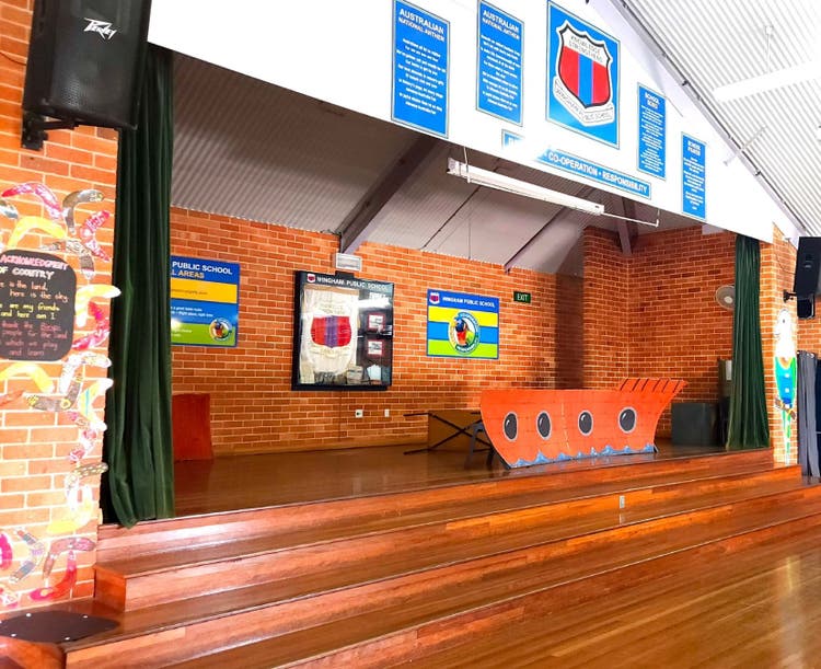 Image of the school hall, with stage, steps and curtain.