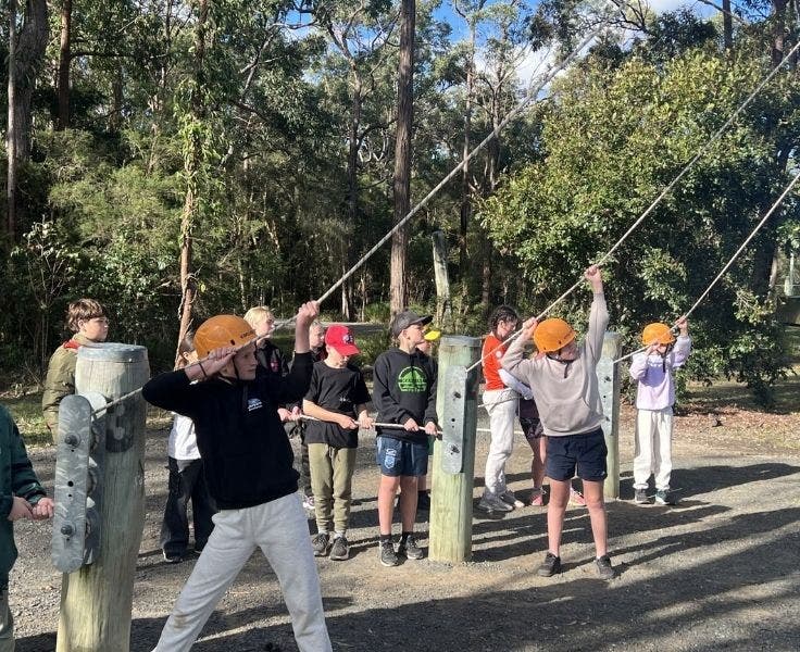 Students on excursion, participating in the high ropes confidence course.
