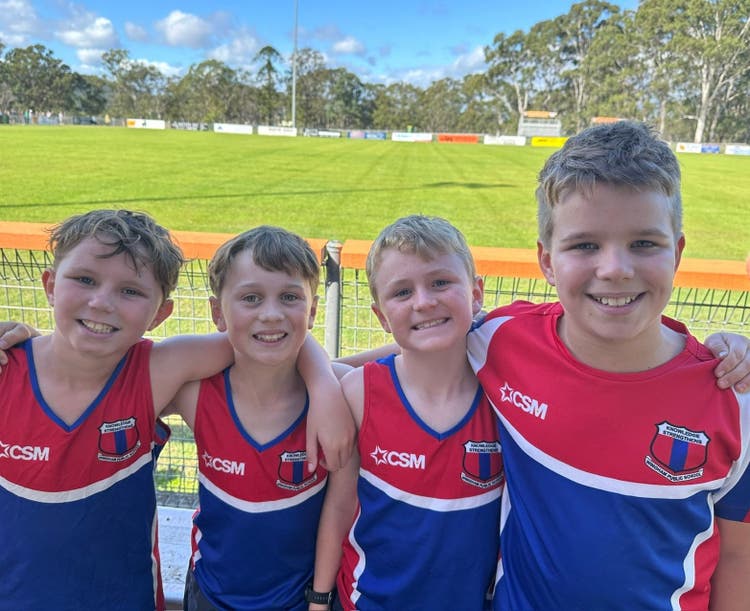 Group of students in school sport representative uniforms.